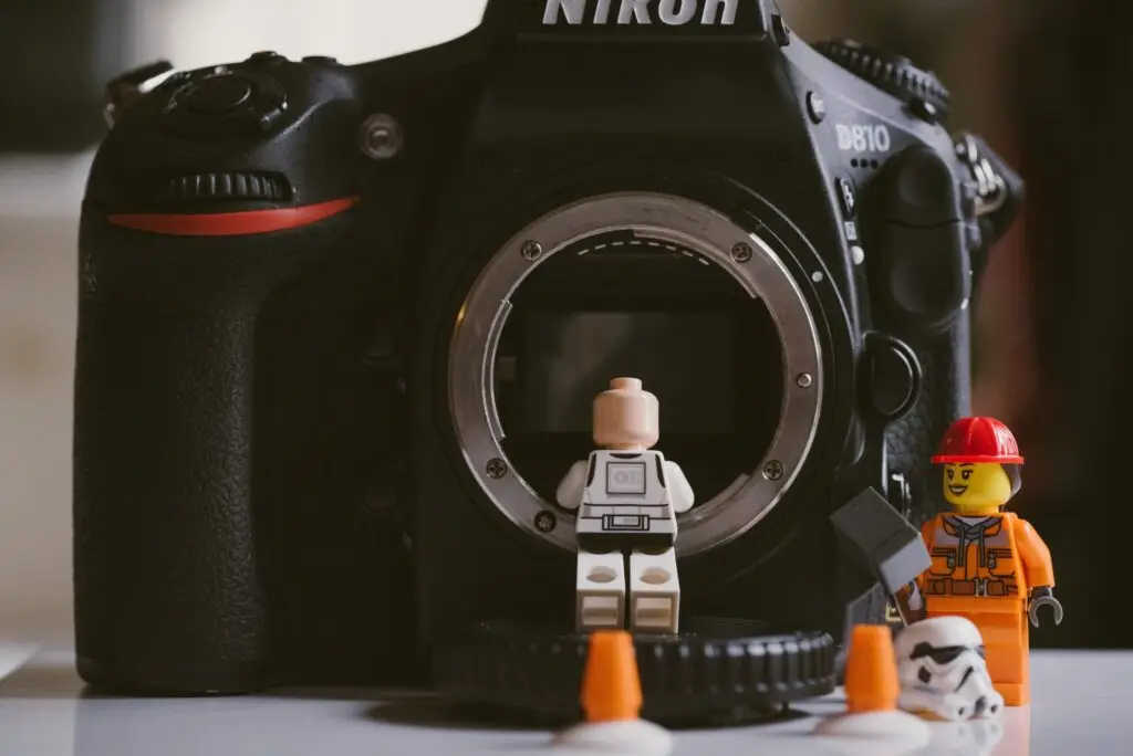 Toy builder figures working on a camera